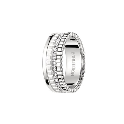Silver ring with intricate design on a white background