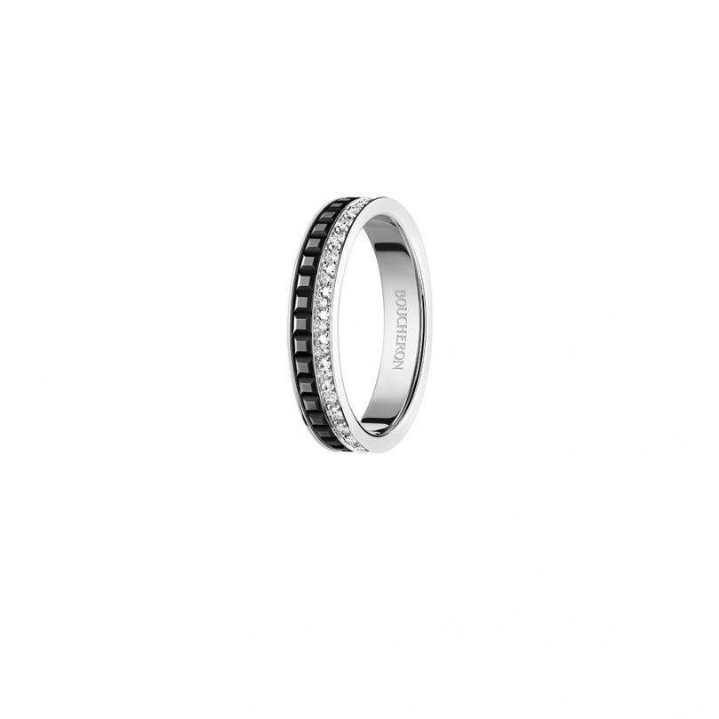 Silver ring with embedded stones on a white background