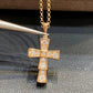 Bvlgari 18K White Gold Serpenti Cross Diamond Necklace Necklace Women Gold cross pendant with diamonds on a chain against a dark textured background