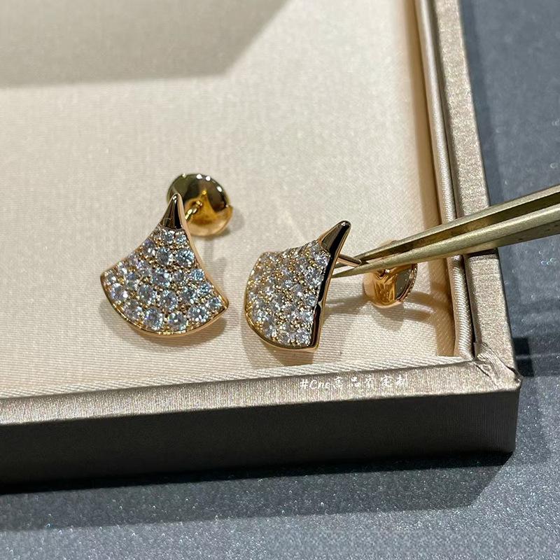 Bvlgari  Divas’ Dream Earringson a gray surface with a box in the background