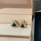Bvlgari  Divas’ Dream Earringswith green gemstones on a jewelry box