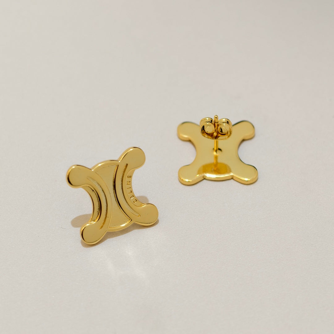 A pair of gold crescent moon stud earrings shown from both the front and back on a light gray background.