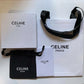 Celine Paris branded packaging set including a white textured box, white shopping bag with black handles, black dust bag, and a white card on a white background.