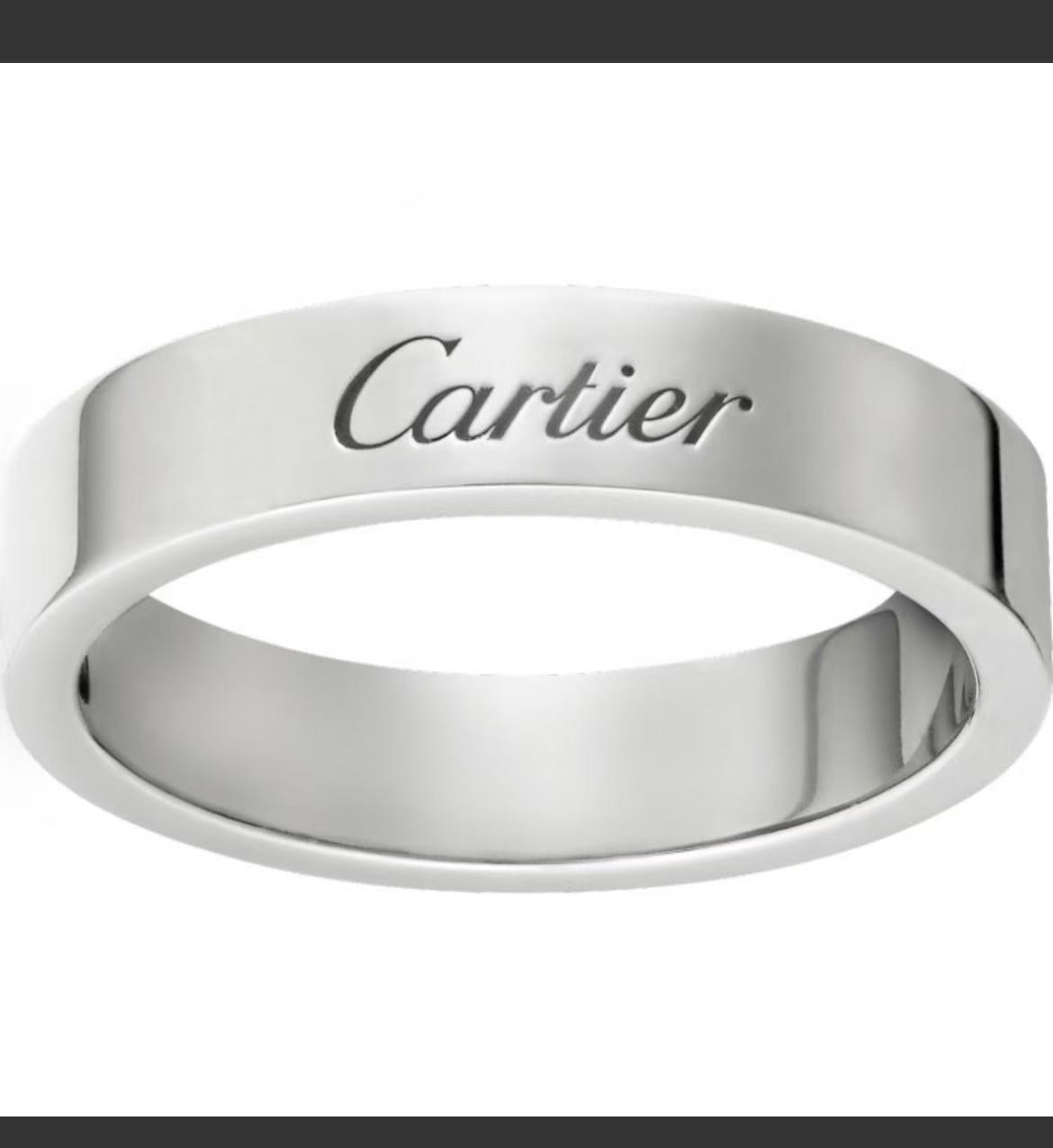 A polished silver-tone Cartier ring with the brand name engraved on the front, shown against a plain white background.