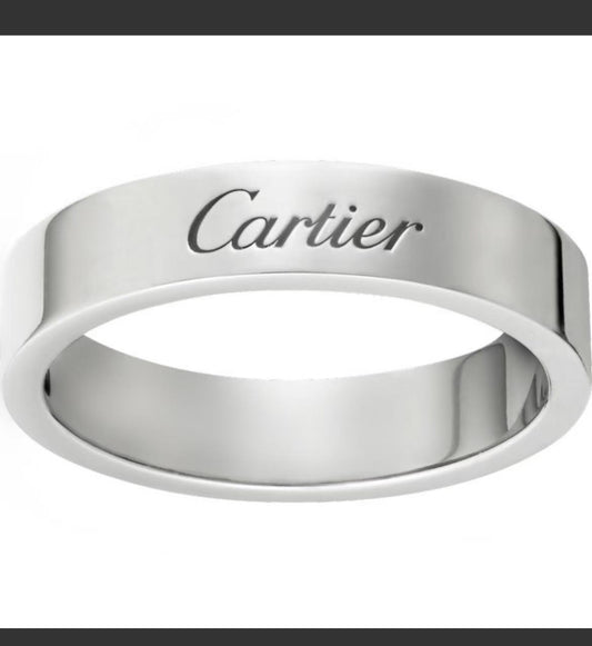 A polished silver-tone Cartier ring with the brand name engraved on the front, shown against a plain white background.