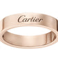 A rose gold Cartier ring with the brand name engraved on the outer band, shown against a plain white background.