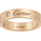 A rose gold Cartier band ring with a single round-cut clear gemstone and engraved Cartier branding on the exterior and interior, shown against a plain white background.