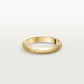 Gold Cartier ring on a light gray background