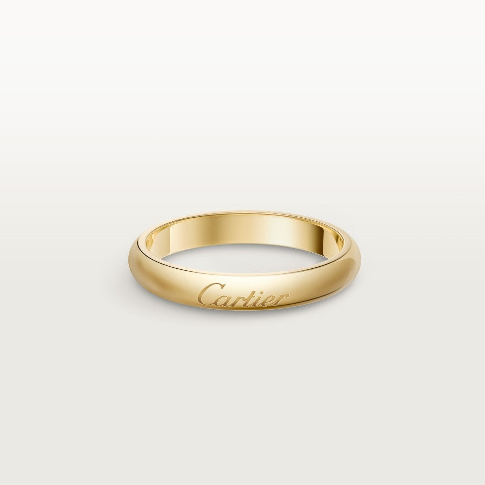 Gold Cartier ring on a light gray background