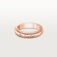 Rose gold Cartier ring with a diamond on a light gray background