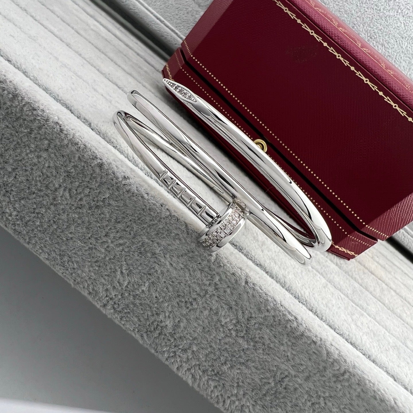 Silver pen with a red leather case on a textured surface