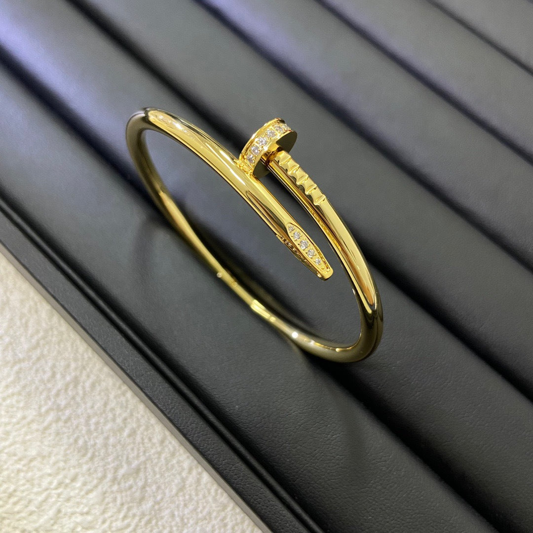 Gold bracelet on a textured surface