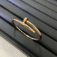 Gold bracelet with small diamonds on a black surface