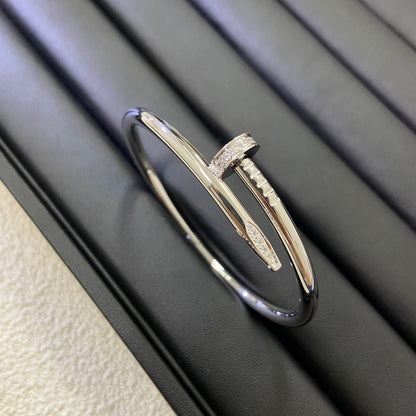 Gold bracelet with diamond accents on a dark surface