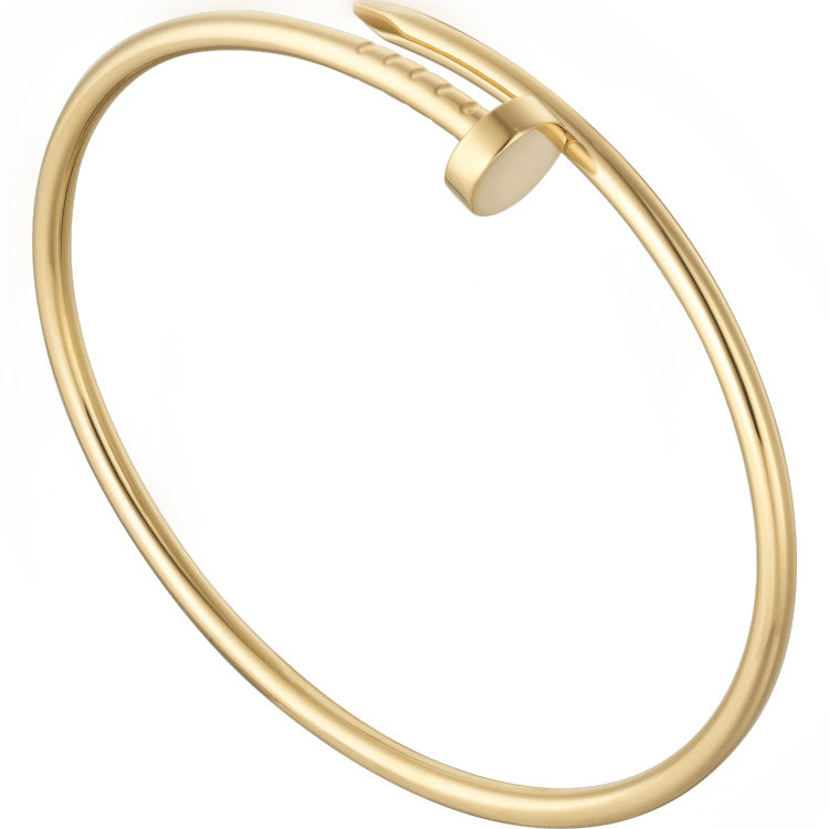 Gold bangle on a white background