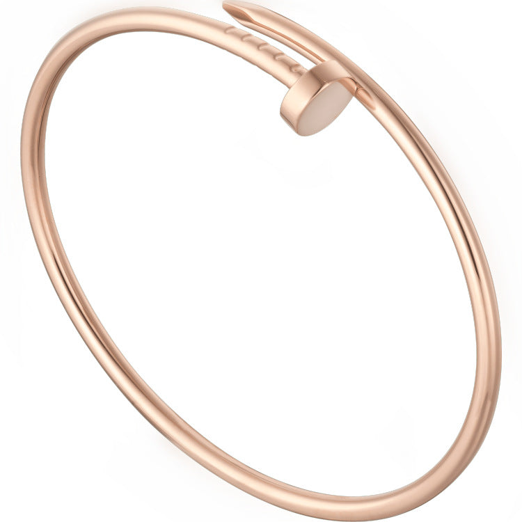 Rose gold bangle on a white background