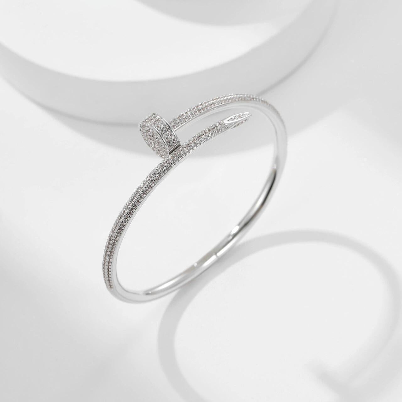 Silver bracelet with small diamonds on a white background