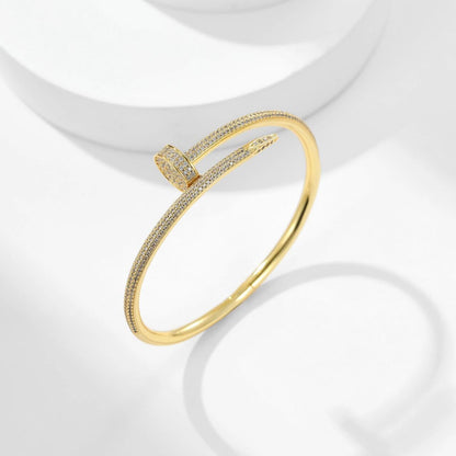 Gold bracelet with diamond accents on a white background