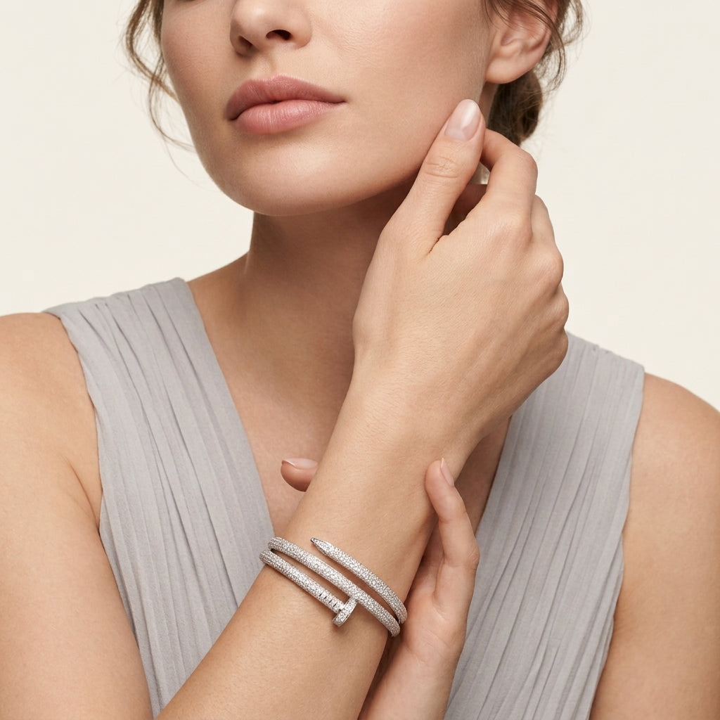 Woman wearing a silver bracelet on a neutral background