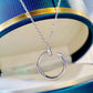 Silver necklace with a unique pendant on a blue and gold background