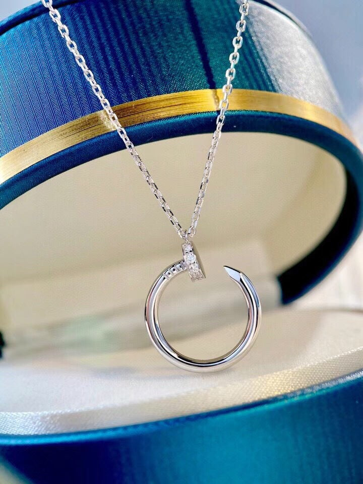 Silver necklace with a unique pendant on a blue and gold background