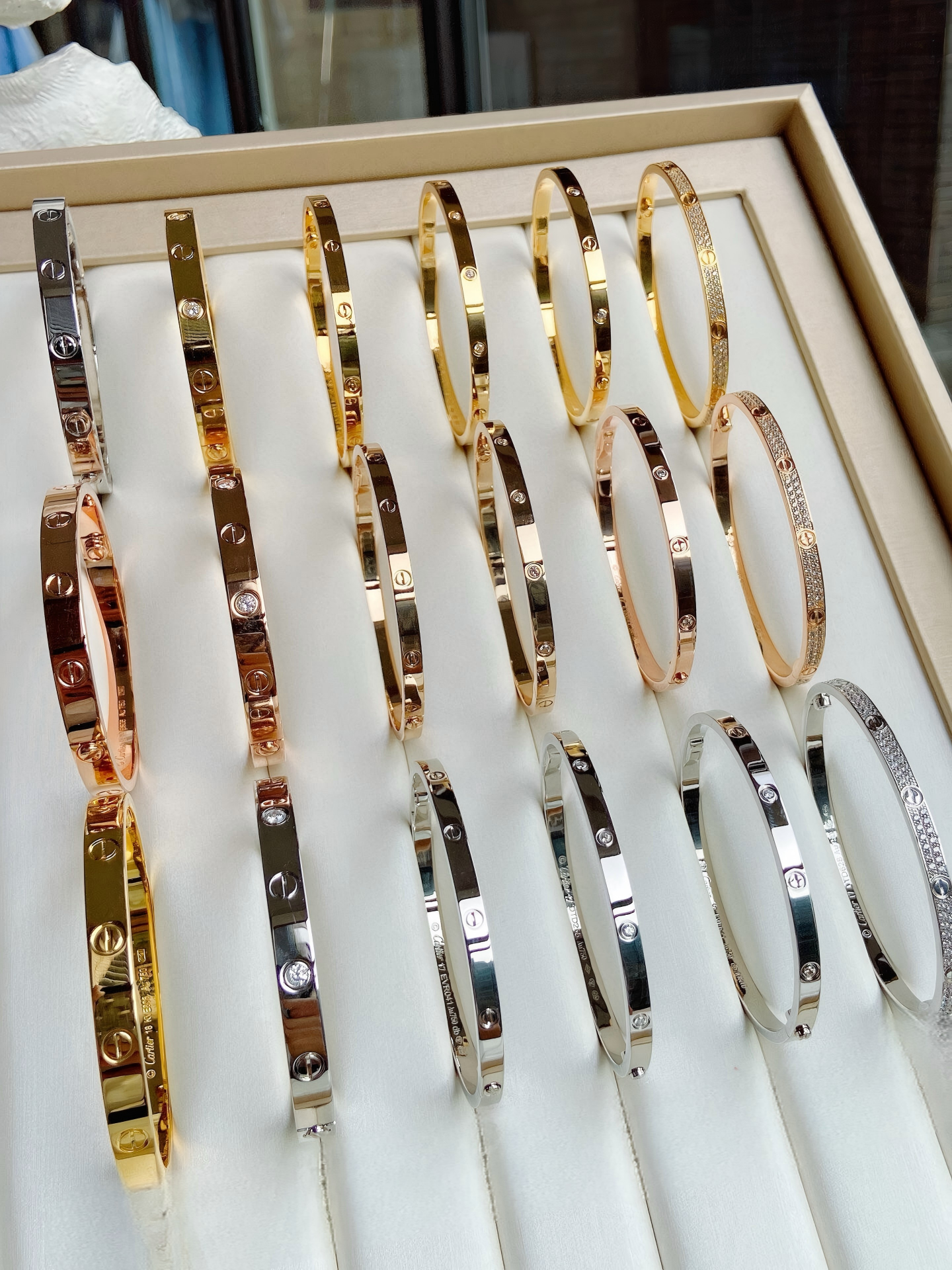 Set of gold and silver bracelets displayed in a box