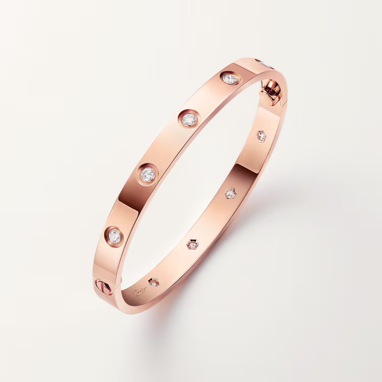 Rose gold bracelet with diamonds on a light gray background