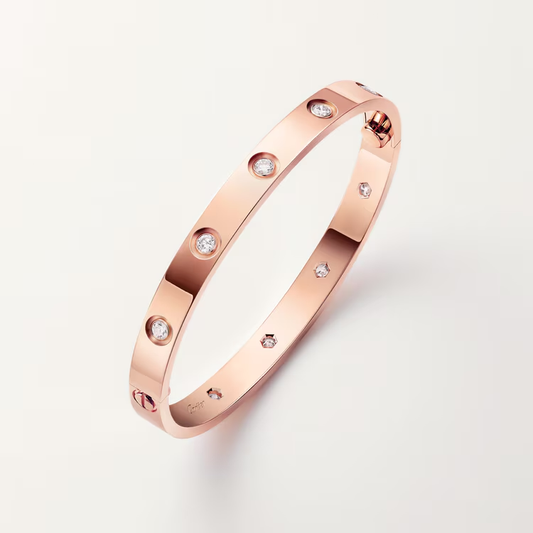 Rose gold bracelet with diamonds on a light gray background