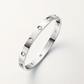 Silver bracelet with small diamonds on a light gray background