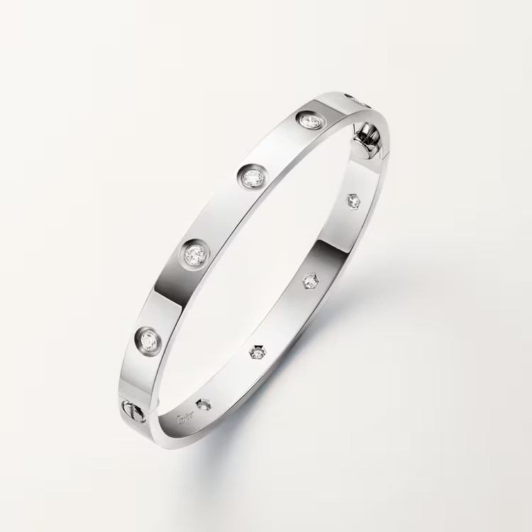 Silver bracelet with small diamonds on a light gray background