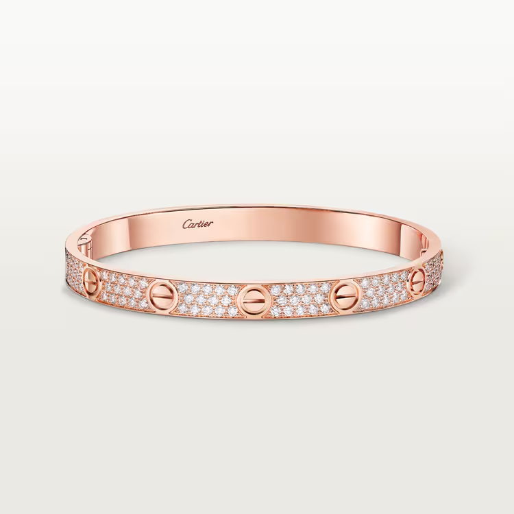 Rose gold bracelet with diamond accents on a light gray background