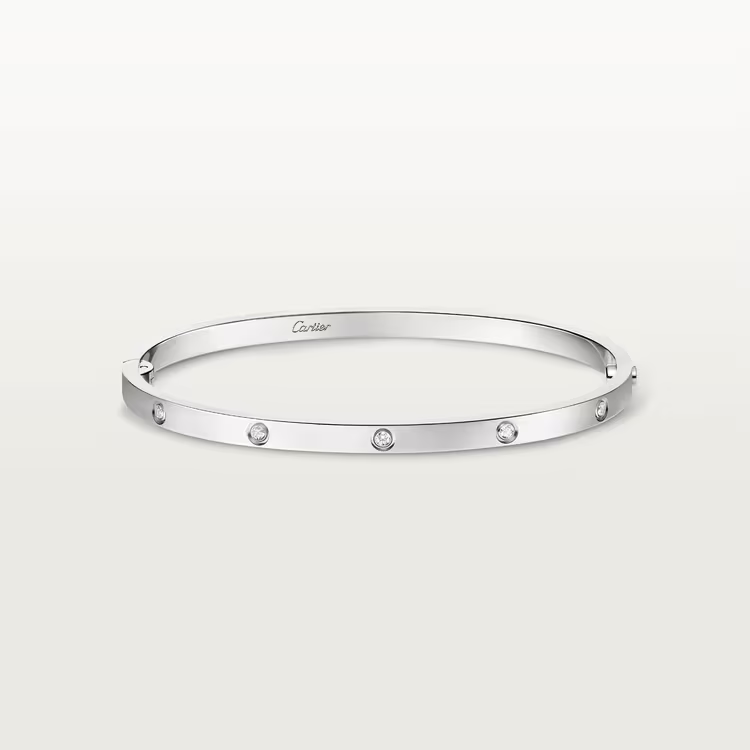 Silver bracelet with small stones on a light gray background