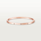 Rose gold bracelet with small diamonds on a light gray background
