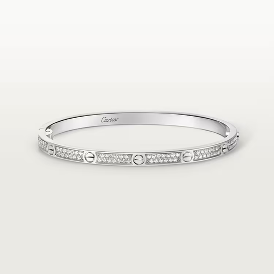 Silver bracelet with diamond accents on a white background