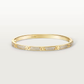 Gold bracelet with diamond accents on a light gray background