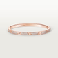 Rose gold bracelet with diamonds on a light gray background