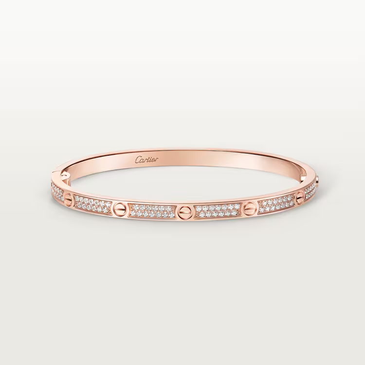 Rose gold bracelet with diamonds on a light gray background