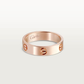 Rose gold Cartier ring on a light gray background