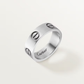 Silver Cartier ring with engraved design on a light gray background