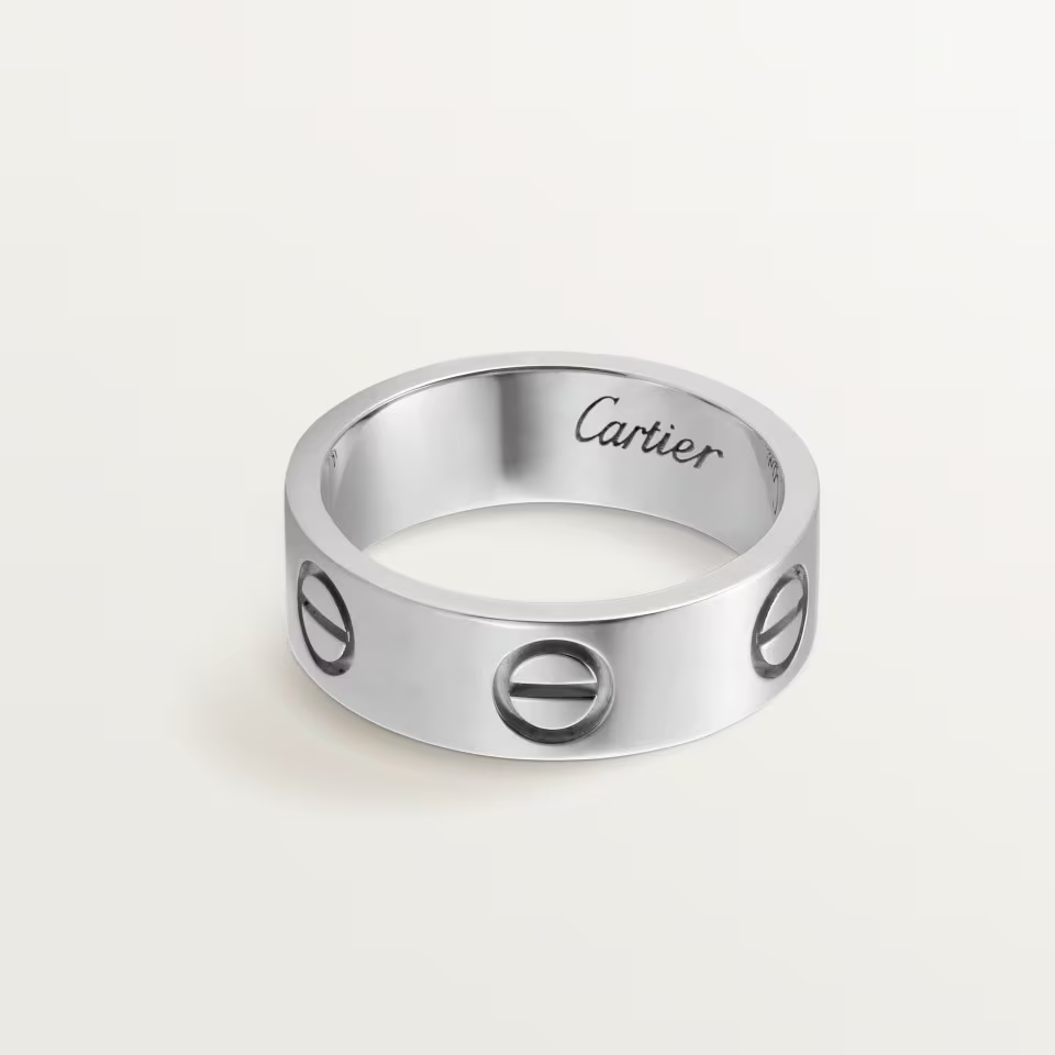 Silver Cartier ring on a light gray background