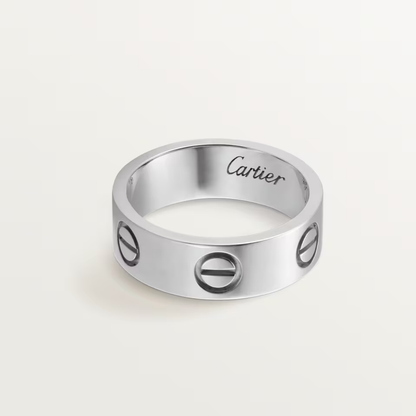 Silver Cartier ring on a light gray background