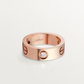 Rose gold Cartier ring with a diamond on a light gray background