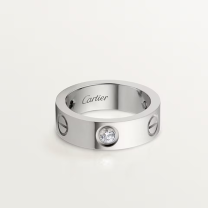 Cartier ring with a diamond on a light gray background