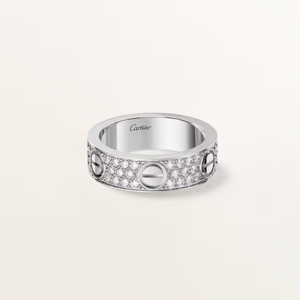 Silver ring with Cartier branding on a light gray background