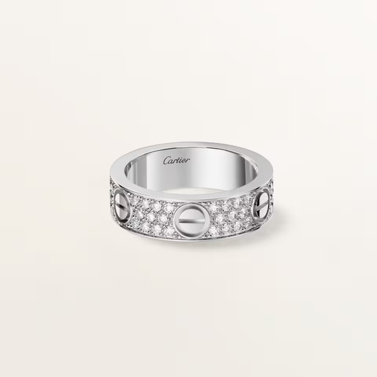 Silver ring with Cartier branding on a light gray background