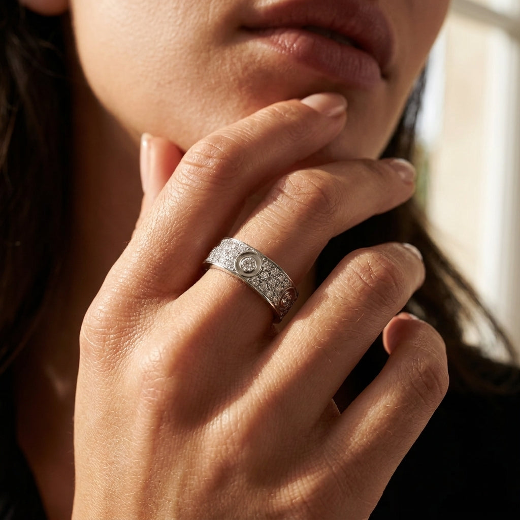 Close-up of a hand wearing a diamond ring with a blurred background