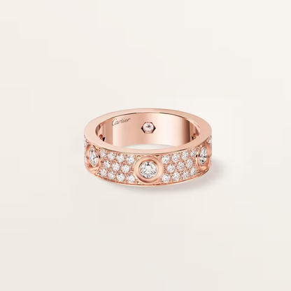 Rose gold ring with diamonds on a light beige background