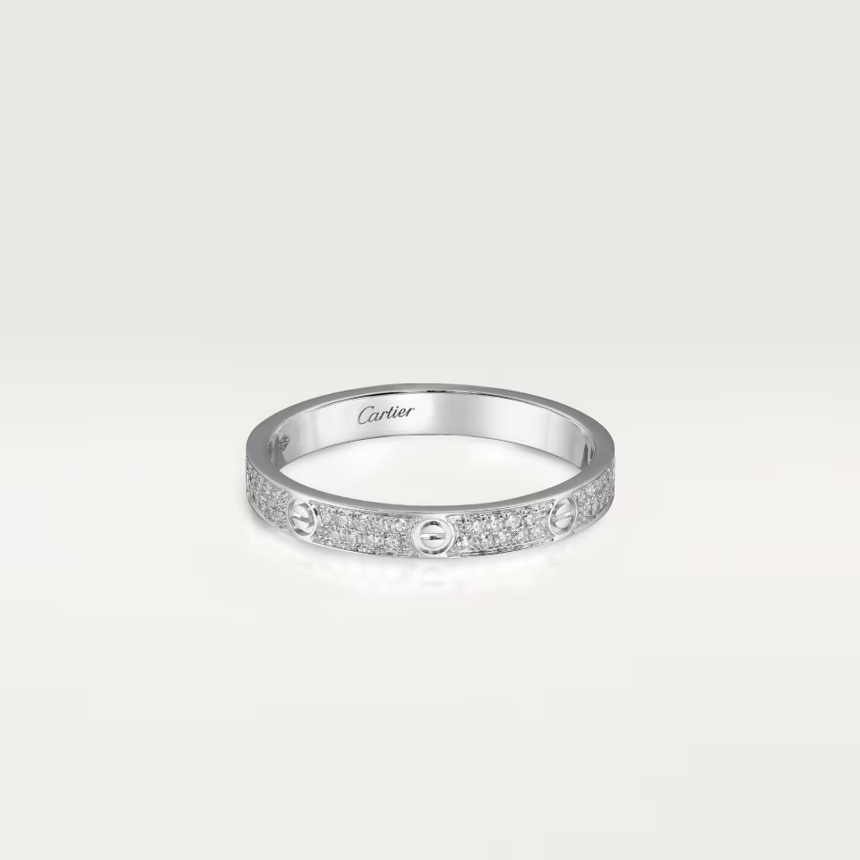 Silver ring with Cartier logo on a light gray background