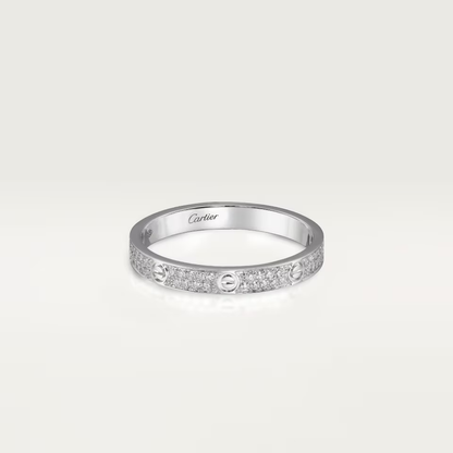 Silver ring with Cartier logo on a light gray background