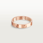 Rose gold Cartier ring on a light gray background